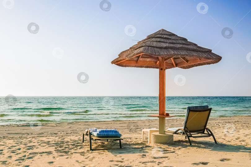 Скачать Пляжный фон на каникулах - одинокий зонтик на пляже Персидского залива в Дубае. фотосток Ozero