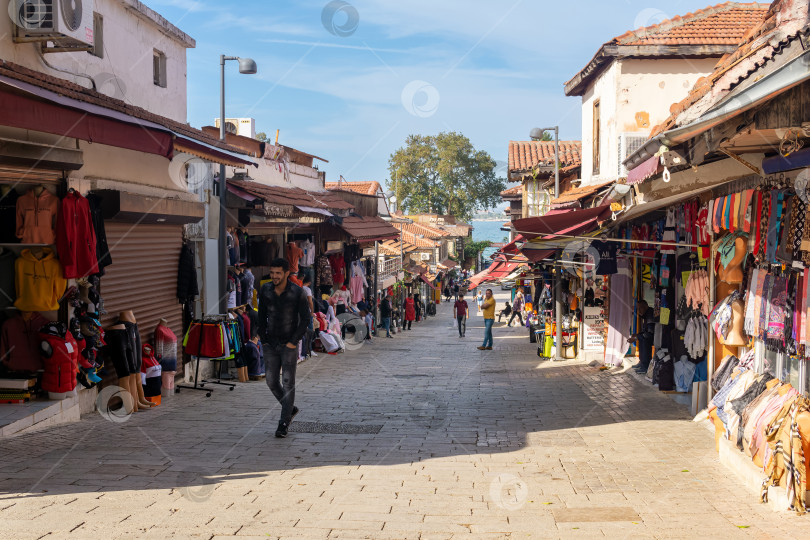 Скачать прибрежная улица с магазинами и лавками с товарами для туристов в историческом районе Сиде в Манавгате, Турция фотосток Ozero