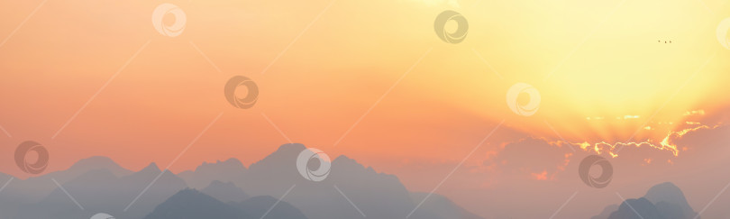 Скачать яркое небо на закате или восходе солнца с туманными горами фотосток Ozero