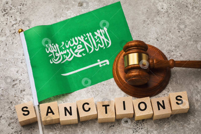 Скачать Флаг Саудовской Аравии, судейский молоток и деревянные кубики с текстом, концепция на тему санкций страны фотосток Ozero