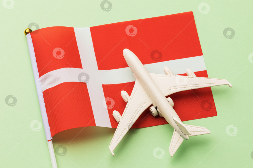 Скачать Шведский флаг и игрушечный самолет на цветном фоне, концепция полета в Швецию, вид сверху фотосток Ozero