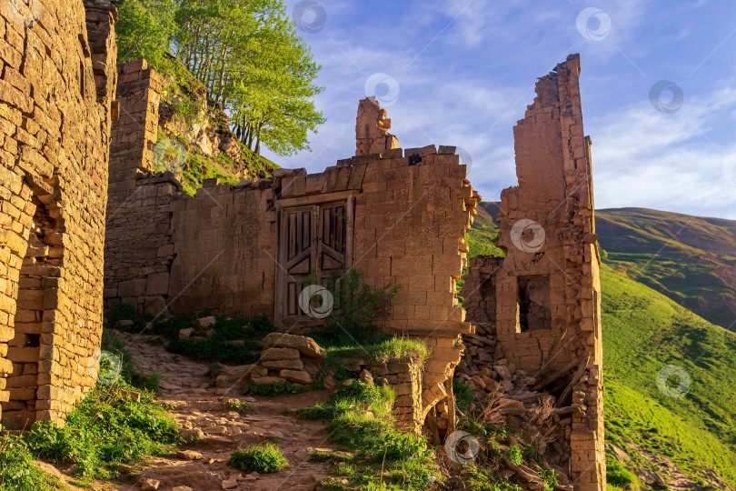Скачать руины дома в заброшенной деревне Гамсутль с видом на горы фотосток Ozero