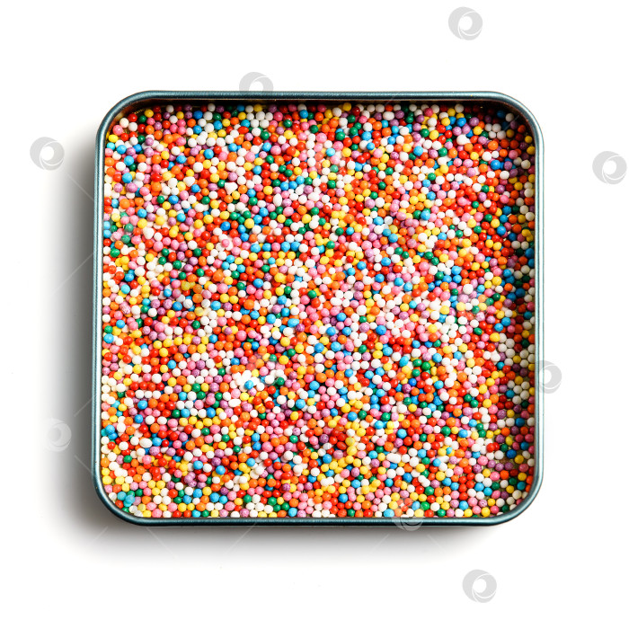 Скачать Разноцветная посыпка кондитерских изделий на белом фоне - вид сверху фотосток Ozero