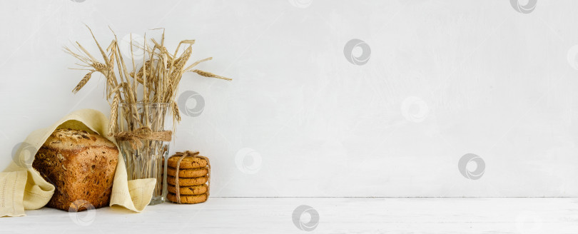 Скачать баннер на белом фоне стены и место для копирования - домашний зерновой хлеб и льняная салфетка. Декор для приготовления пищи на домашней кухне. фотосток Ozero