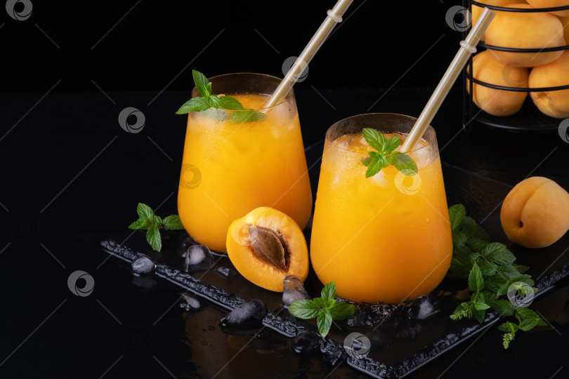 Скачать Свежий сладкий абрикосовый сок и мята на черном фоне фотосток Ozero