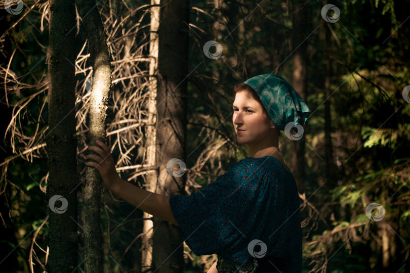 Скачать молодая женщина в традиционной народной крестьянской одежде в хвойном лесу фотосток Ozero