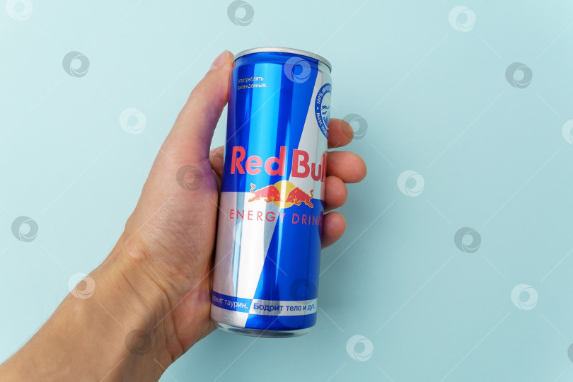 Скачать Тюмень, Россия - 08 декабря 2021 года: Банка с логотипом Red Bull, энергетического напитка, продаваемого австрийской компанией Red Bull GmbH. Избирательный фокус фотосток Ozero