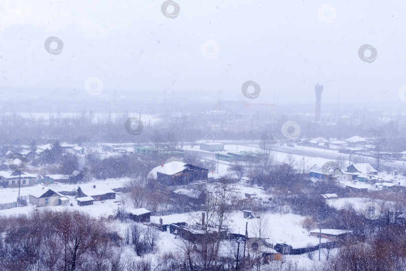 Скачать Сильный снегопад зимой в сибирском городе. Шум, ветер, избирательный фокус фотосток Ozero