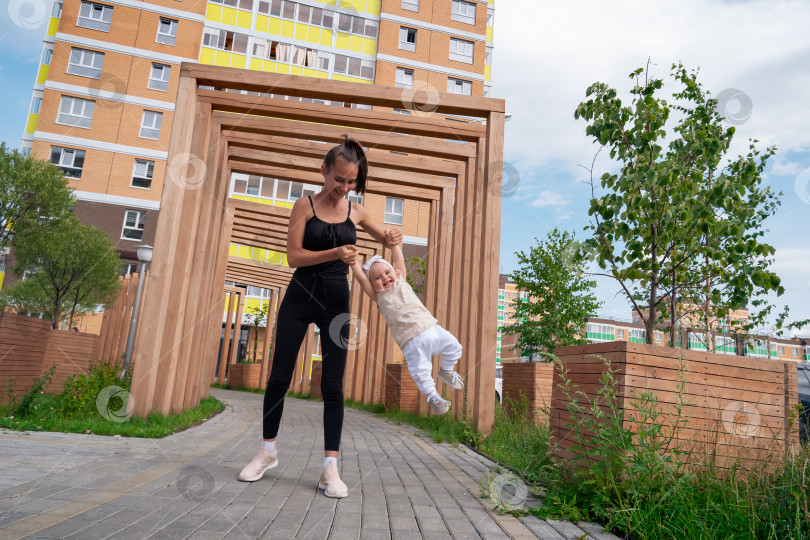 Скачать мама и ребенок гуляют и играют в городском дворе фотосток Ozero