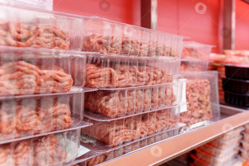 Скачать Сырой мясной фарш в прозрачном пластиковом контейнере продают в супермаркетах. Избирательный фокус фотосток Ozero