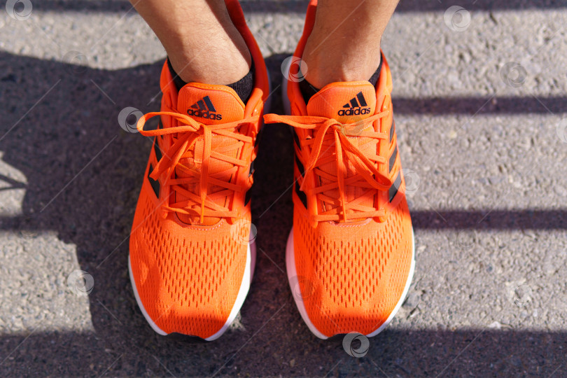 Скачать Тюмень, Россия - 15 июня 2022 года: Новые кроссовки Adidas оранжево-кораллового цвета, eq21 run. фотосток Ozero