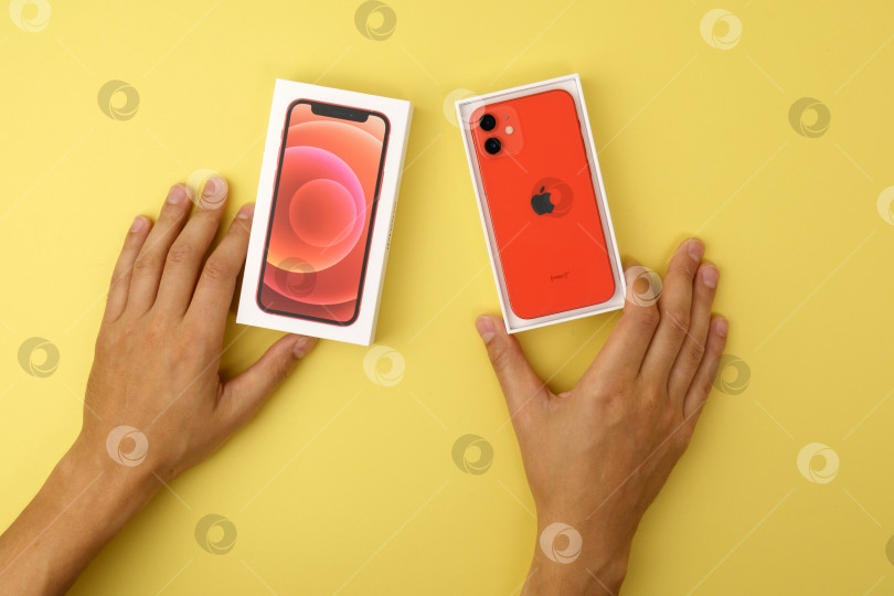 Скачать Тюмень, Россия - 18 июля 2022 года: iPhone 12 mini представлен в красном цвете. Смартфон с мультисенсорным экраном производства Apple Computer, Inc. фотосток Ozero