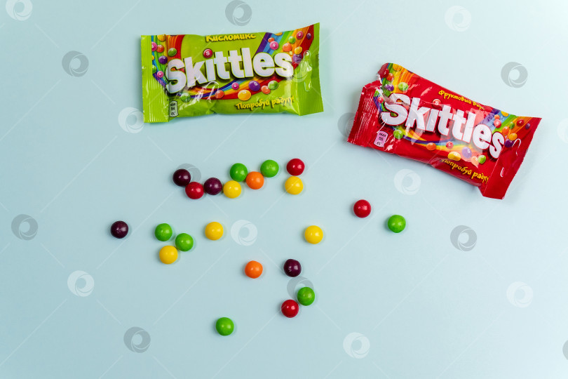 Скачать Тюмень, Россия - 27 декабря 2021 года: Оригинальные конфеты марки Skittles. Разноцветный фон. вкусные сладкие кегли фотосток Ozero