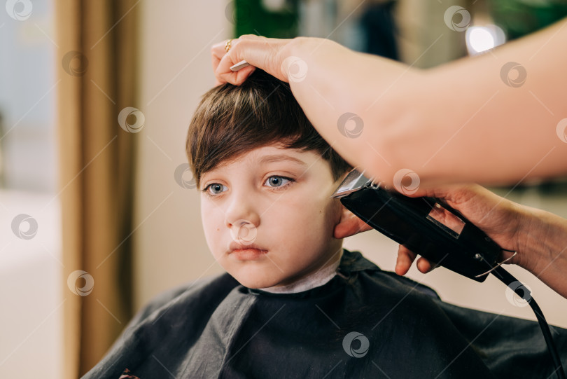 Скачать Стрижка для маленького мальчика, профессиональный парикмахер делает стрижку. Прическа для детей фотосток Ozero