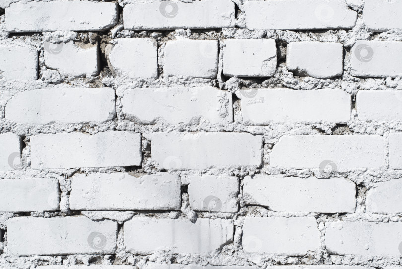 Скачать Текстурированный фон кирпичной стены, выкрашенной белой краской, крупным планом. Фон фотосток Ozero