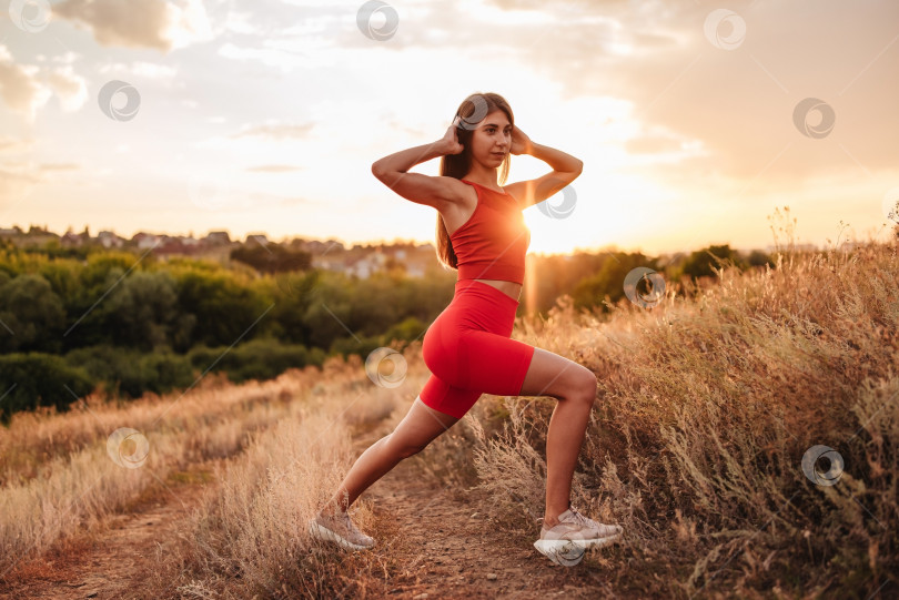 Скачать Фитнес-женщина, готовая к пробежке на закате или восходе солнца по пляжу. Спортсменка в мощной позе на стартовой линии. фотосток Ozero
