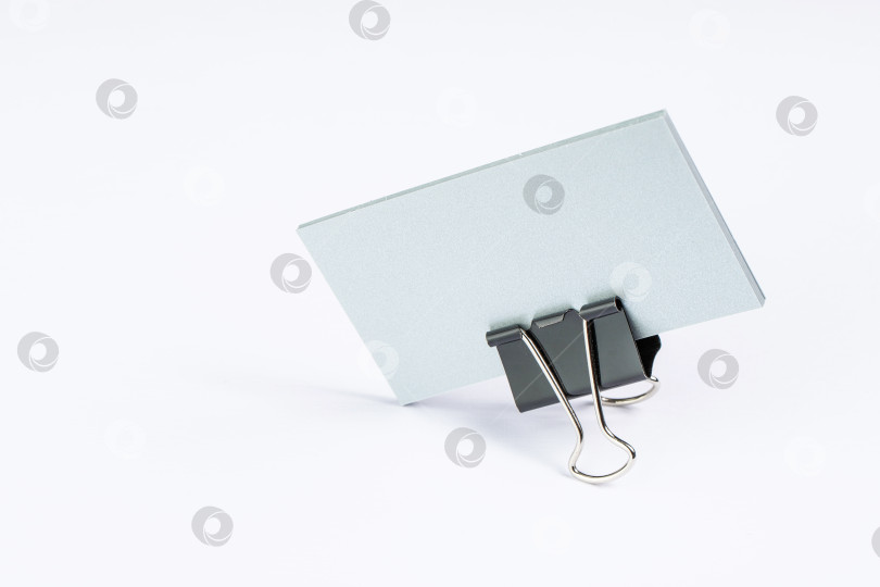 Скачать пачка бумажных заготовок для визитных карточек с металлическим зажимом на светлом фоне, изолированная фотосток Ozero