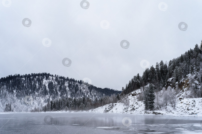 Скачать Зимний горный пейзаж. Река возле заснеженных гор заросла фотосток Ozero