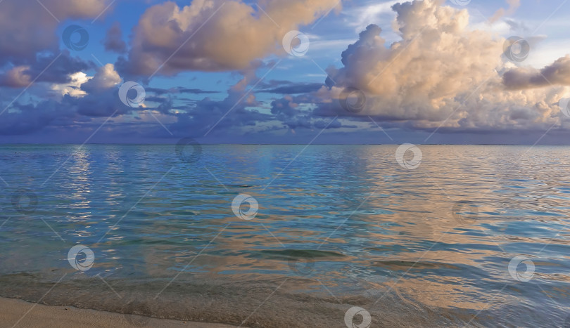 Скачать Аквамариновый океан спокоен. В лазурном небе плывут белые и голубые облака. фотосток Ozero