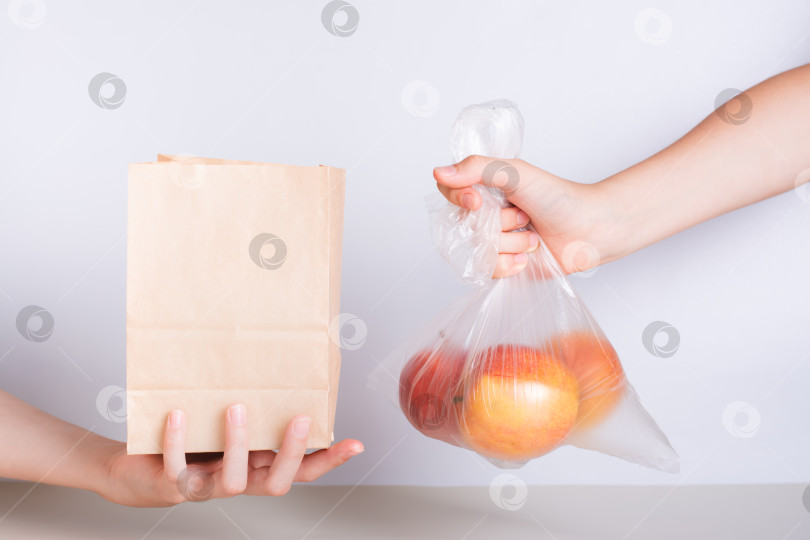 Скачать Рука с одноразовым прозрачным пакетом яблок и рука с фотосток Ozero