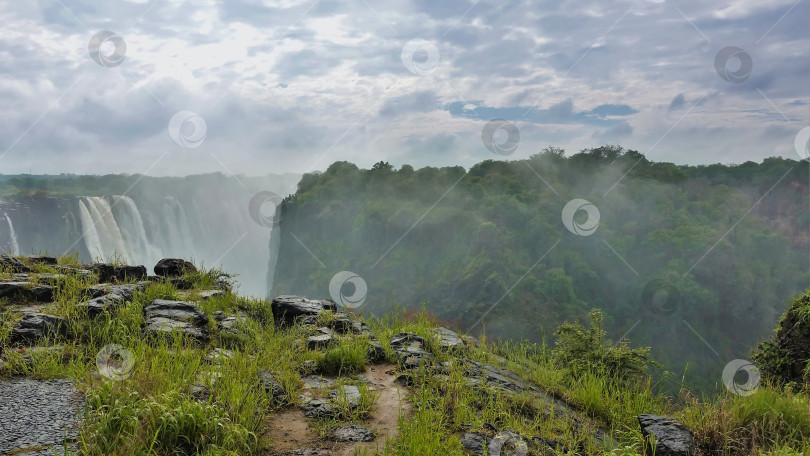 Скачать Уникальный водопад Виктория. Потоки воды устремляются в ущелье. Зимбабве фотосток Ozero