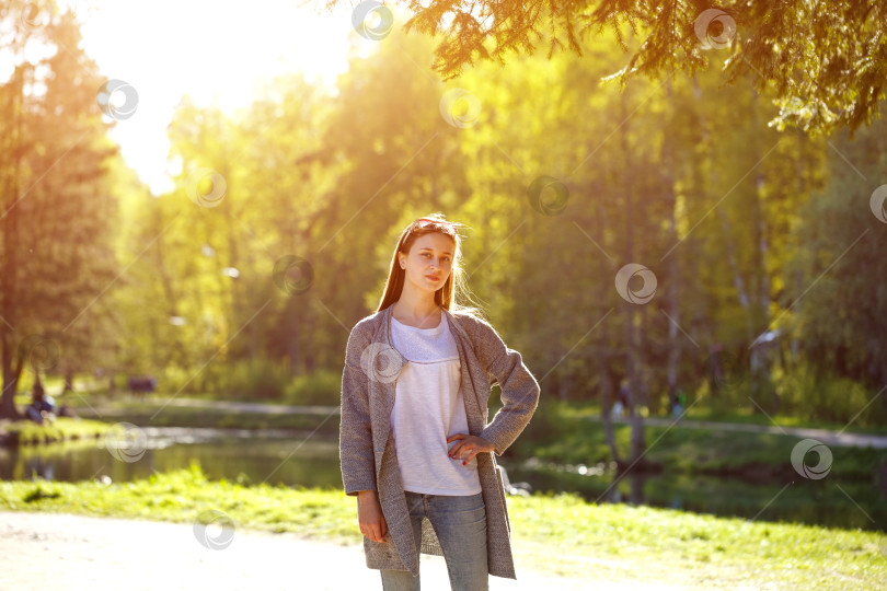 Скачать молодая женщина позирует на солнышке в парке у озера на фоне фотосток Ozero