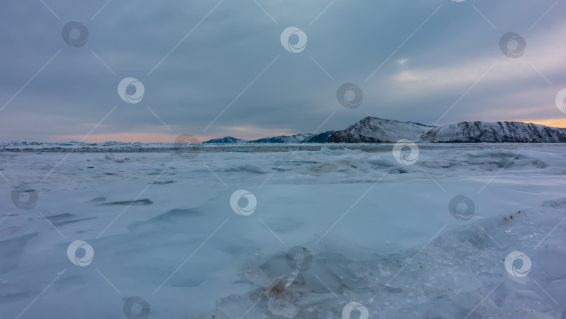 Скачать Закат над замерзшим озером. На поверхности находятся осколки снега и льда фотосток Ozero