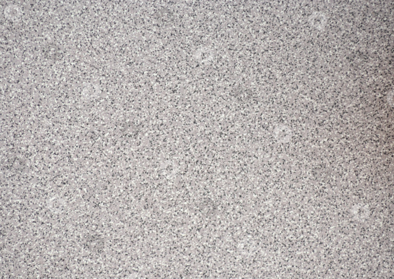 Скачать Серый гранит, полированная поверхность из натурального камня со множеством мелких включений черного и белого цветов. фотосток Ozero