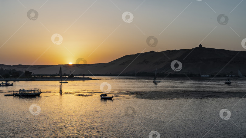 Скачать Закат на берегу Нила. Солнце прячется за песчаными дюнами. фотосток Ozero