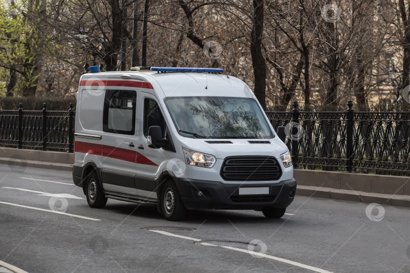 Скачать Машина скорой помощи движется по городской улице фотосток Ozero