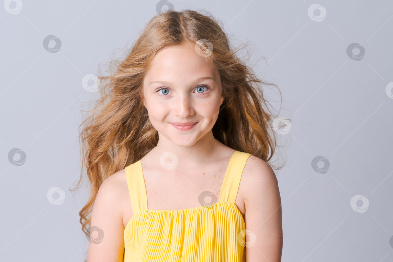 Скачать Портрет счастливой нежной девочки-подростка с голубыми глазами и веснушками, смотрящей фотосток Ozero