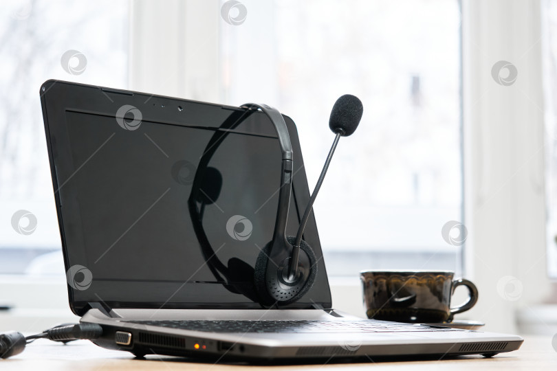 Скачать ноутбук с наушниками и чашкой кофе на столе крупным планом фотосток Ozero