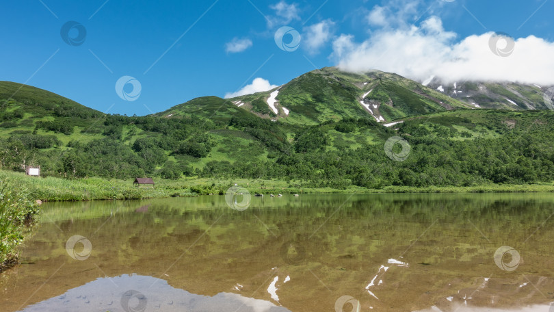 Скачать Спокойное прозрачное озеро окружено горами. фотосток Ozero