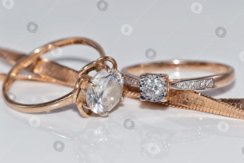 Скачать Тонкое элегантное золотое кольцо с бриллиантом и золотой цепочкой фотосток Ozero