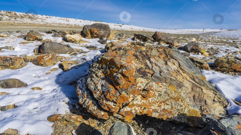 Скачать Живописные валуны разбросаны по заснеженной долине. фотосток Ozero