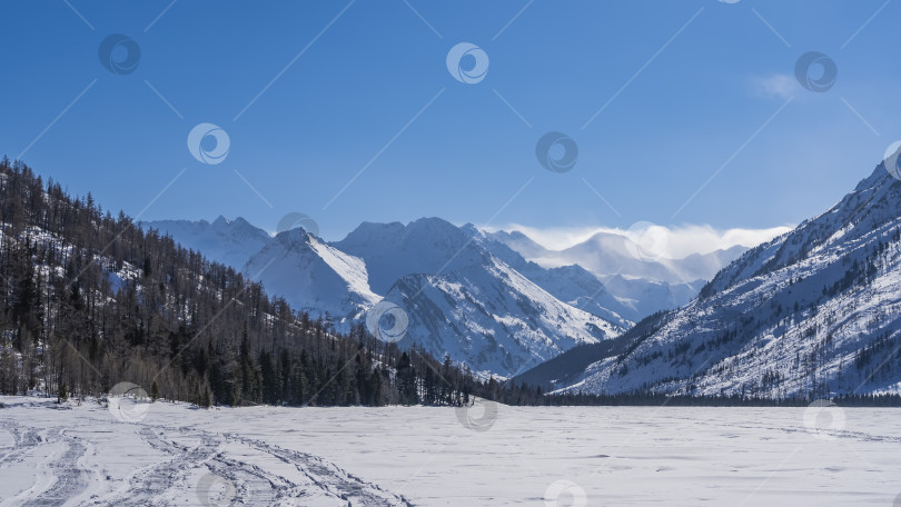 Скачать Замерзшее озеро окружено горами. фотосток Ozero