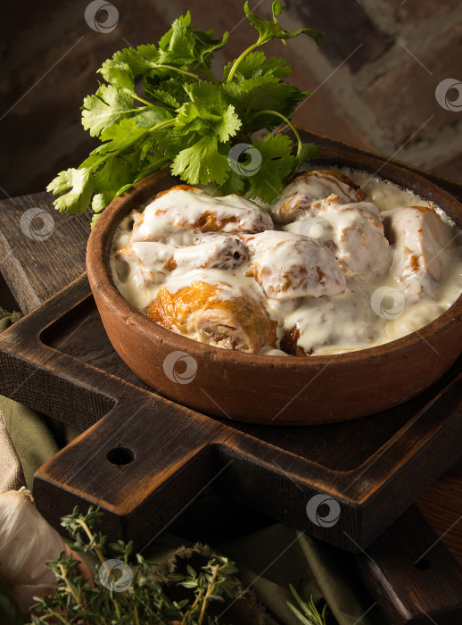 Скачать Вертикальный снимок курицы, покрытой сливочным соусом фотосток Ozero