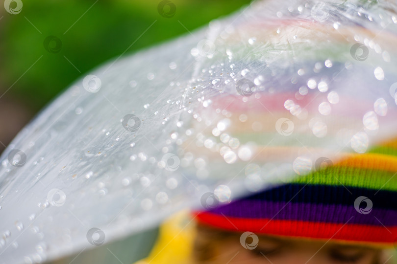 Скачать маленькая светловолосая девочка улыбается, прыгает по весенним лужам в желтом дождевике и резиновых сапогах с зонтиком фотосток Ozero