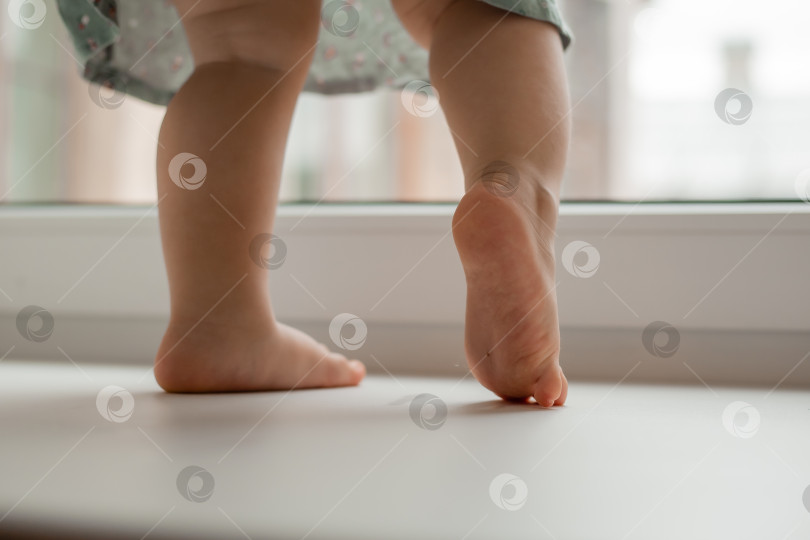 Скачать ножки ребенка на подоконнике дома возле окна крупным планом фотосток Ozero