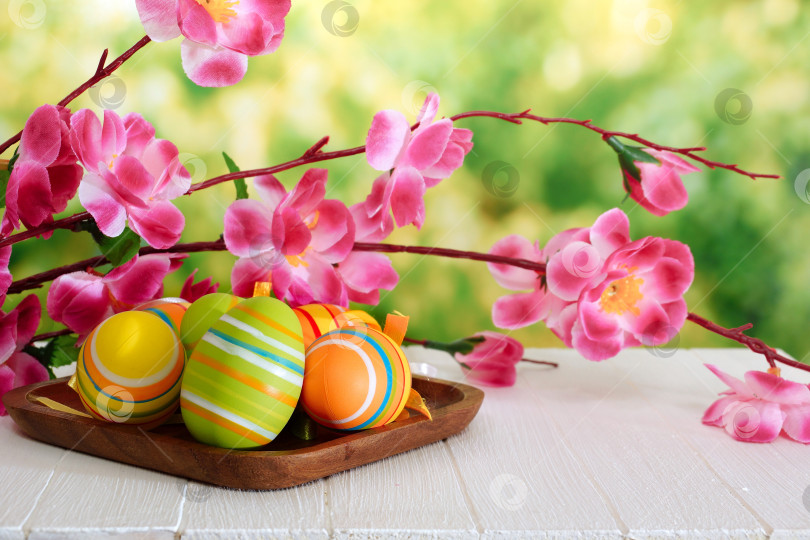 Скачать Разноцветные яйца и ветка вишни на белом деревянном столе фотосток Ozero