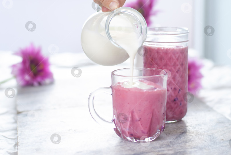 Скачать Красивый легкий фруктовый йогурт в стакане белого и розового цветов. Ягодный смузи. Молоко натуральные органические продукты фотосток Ozero