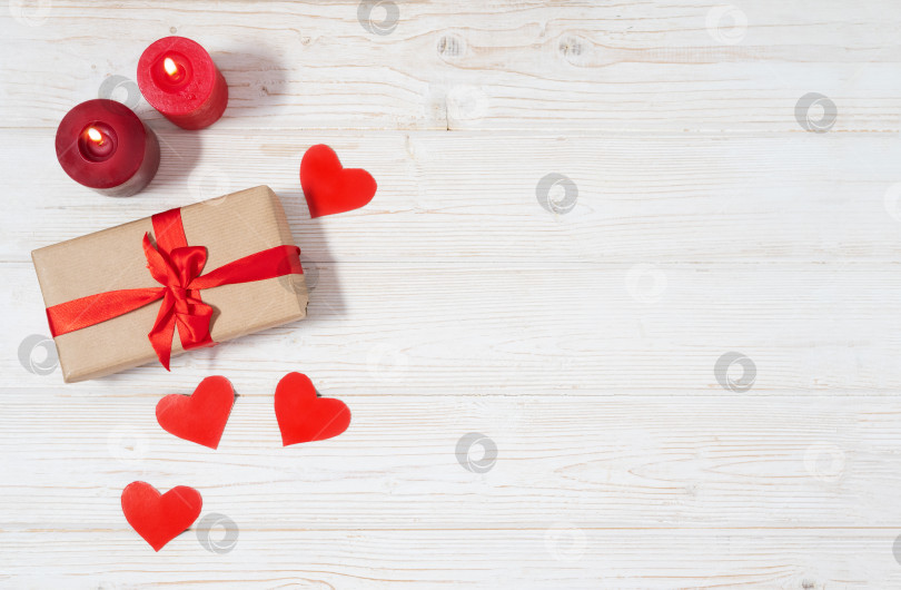 Скачать День святого Валентина, подарочная коробка из крафт-бумаги с красной лентой и свечами. Деревенский стиль фотосток Ozero
