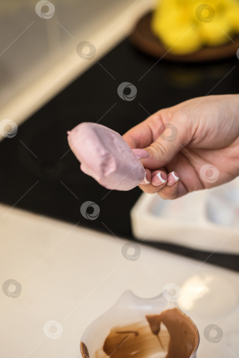 Скачать женщина-кондитер макает зефир на палочке в шоколад. концепция домашней пекарни. фотосток Ozero