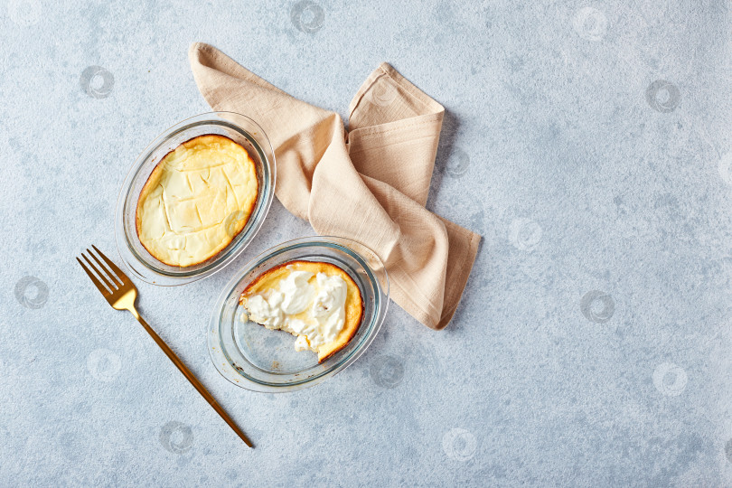 Скачать Вкусная творожная запеканка в порционных стеклянных формах со сметаной. Традиционная русская кухня на завтрак - Запеканка фотосток Ozero