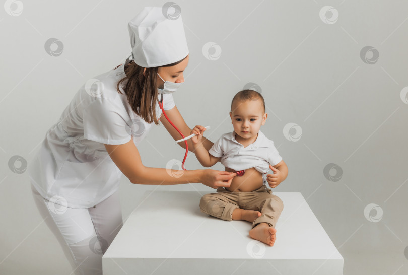 Скачать Детский врач осматривает годовалого мальчика с помощью стетоскопа в больничном центре. концепция здравоохранения фотосток Ozero