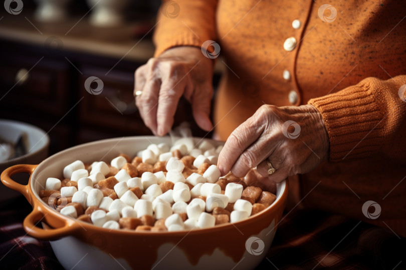 Скачать Руки пожилой женщины готовят запеканку из сладкого картофеля с зефиром. Праздничное зимнее блюдо, подаваемое на семейный ужин в День благодарения. Пюре из сладкого картофеля. Запеченный в духовке сладкий картофель, осеннее блюдо фотосток Ozero