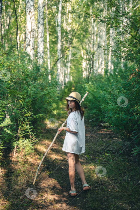 Скачать милая девушка с палкой в лесу ищет грибы фотосток Ozero