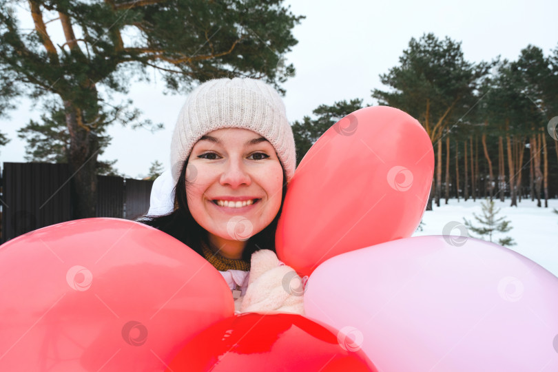Скачать Счастливая женщина с воздушными шарами в форме сердца на открытом воздухе зимой со снегом. День святого Валентина, любовь и увлечение, подарок от парня, признание в любви, образ жизни фотосток Ozero