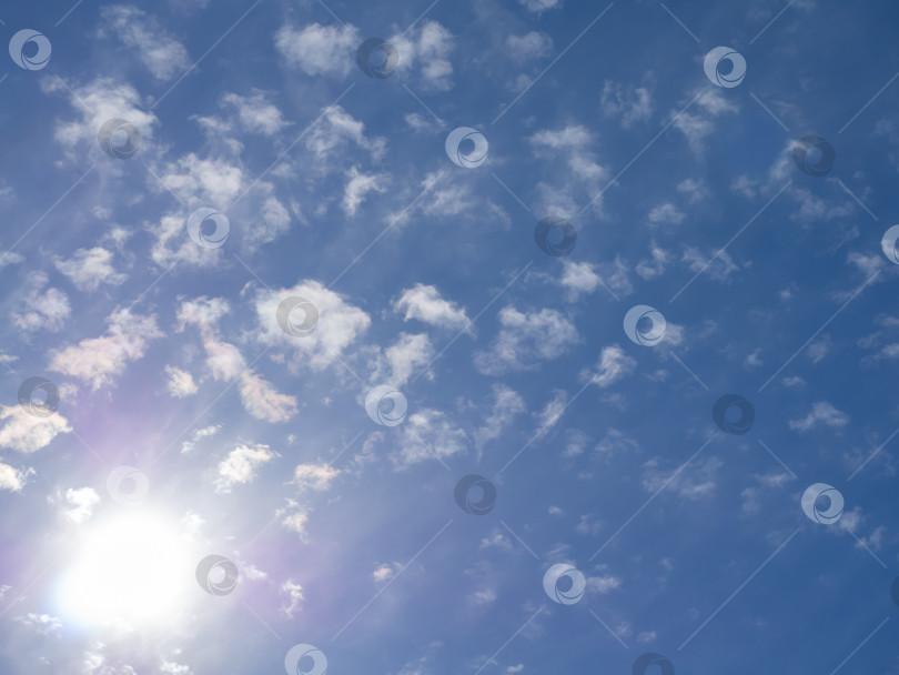 Скачать Яркое солнце сияет на голубом облачном небе. Образы тепла, он фотосток Ozero