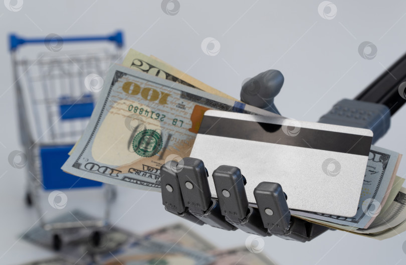 Скачать рука робота держит деньги и кредитную карту. концепция торговли с использованием искусственного интеллекта. фотосток Ozero